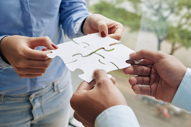 Business students collaborating in a modern classroom, representing real-world learning and leadership preparation